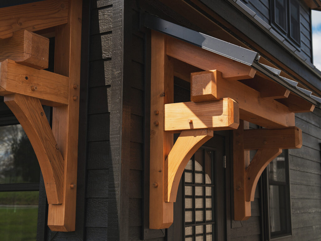 If you’ve been eyeing one of our premium timber frame garages, you’ll love the Ridgeview Loft. At first glance, its striking design, complete with pent roofs over the garage and entry doors, gives it the sophisticated look of a timber frame build. But this model doesn’t just look upscale—it delivers. With glass panel garage doors, black-trimmed windows, and a standing seam metal roof, the Ridgeview Loft checks all the boxes for modern, high-end appeal. When compared to our classic 2-story A-frame garage, the Ridgeview Loft clearly sets itself apart. Its steeper pitched roof and extended dormers make the second floor dramatically more spacious and versatile. Whether you're envisioning turning this space into a mancave, home office, art studio, or guest space, the Ridgeview Loft offers the flexibility to bring your vision to life—while maintaining exceptional value.