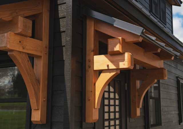 If you’ve been eyeing one of our premium timber frame garages, you’ll love the Ridgeview Loft. At first glance, its striking design, complete with pent roofs over the garage and entry doors, gives it the sophisticated look of a timber frame build. But this model doesn’t just look upscale—it delivers. With glass panel garage doors, black-trimmed windows, and a standing seam metal roof, the Ridgeview Loft checks all the boxes for modern, high-end appeal. When compared to our classic 2-story A-frame garage, the Ridgeview Loft clearly sets itself apart. Its steeper pitched roof and extended dormers make the second floor dramatically more spacious and versatile. Whether you're envisioning turning this space into a mancave, home office, art studio, or guest space, the Ridgeview Loft offers the flexibility to bring your vision to life—while maintaining exceptional value.
