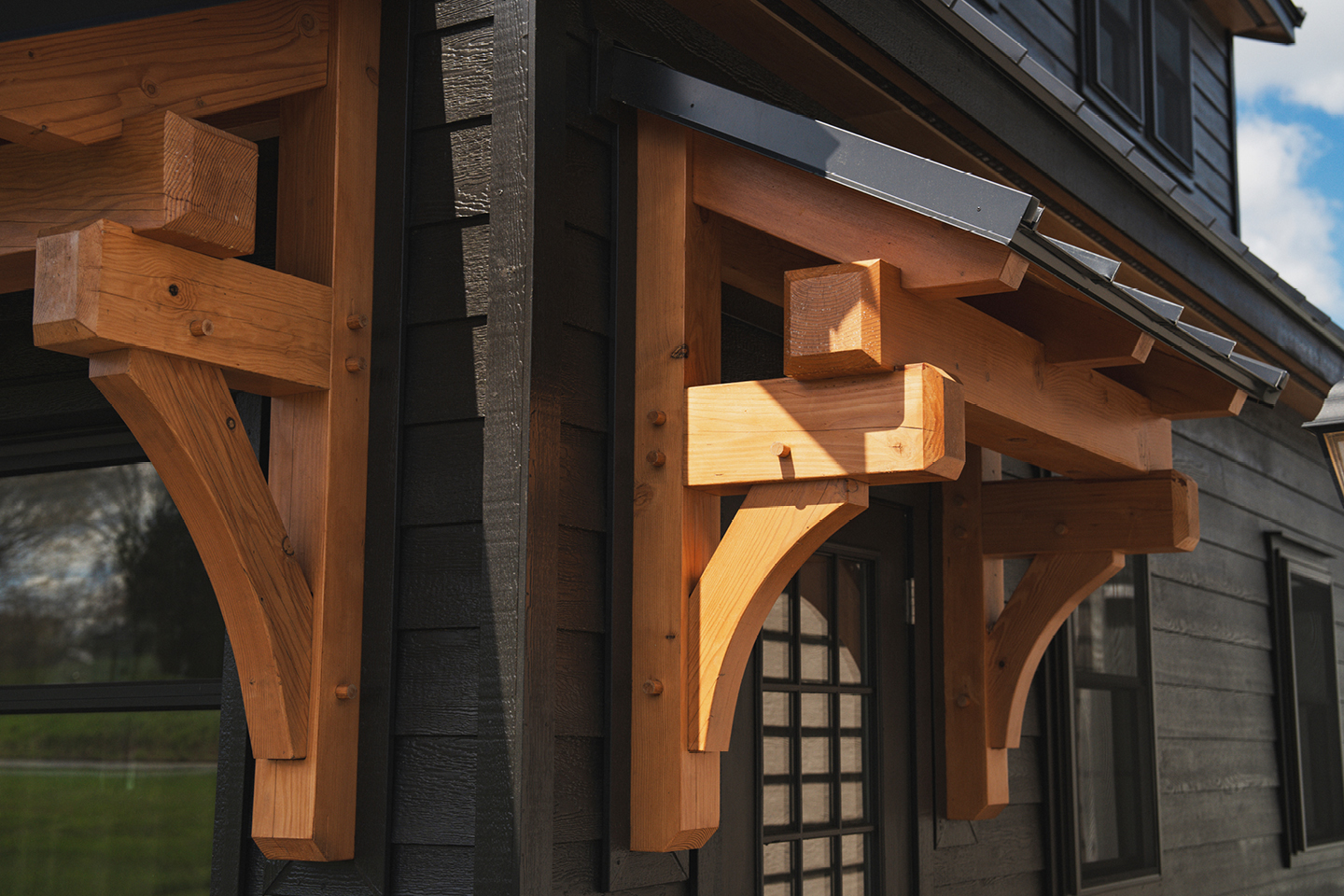 If you’ve been eyeing one of our premium timber frame garages, you’ll love the Ridgeview Loft. At first glance, its striking design, complete with pent roofs over the garage and entry doors, gives it the sophisticated look of a timber frame build. But this model doesn’t just look upscale—it delivers. With glass panel garage doors, black-trimmed windows, and a standing seam metal roof, the Ridgeview Loft checks all the boxes for modern, high-end appeal. When compared to our classic 2-story A-frame garage, the Ridgeview Loft clearly sets itself apart. Its steeper pitched roof and extended dormers make the second floor dramatically more spacious and versatile. Whether you're envisioning turning this space into a mancave, home office, art studio, or guest space, the Ridgeview Loft offers the flexibility to bring your vision to life—while maintaining exceptional value.